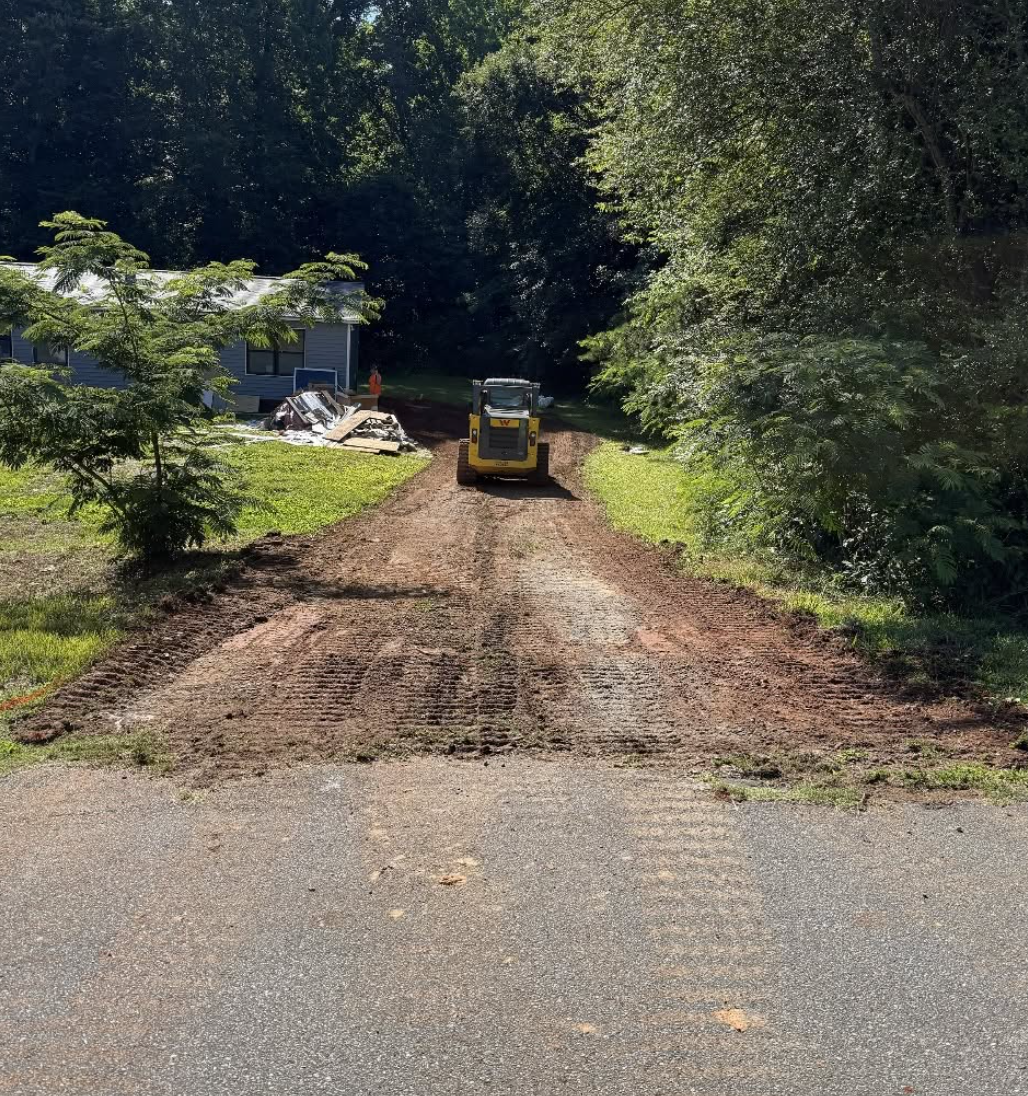 Parking pad excavation completed in Harrisburg, NC with proper grading and compaction.