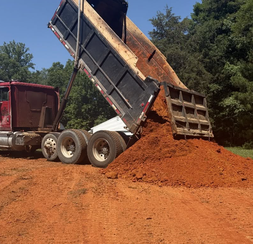 Fill dirt delivery for grading and site preparation by Palmetto South Construction in York County, SC.