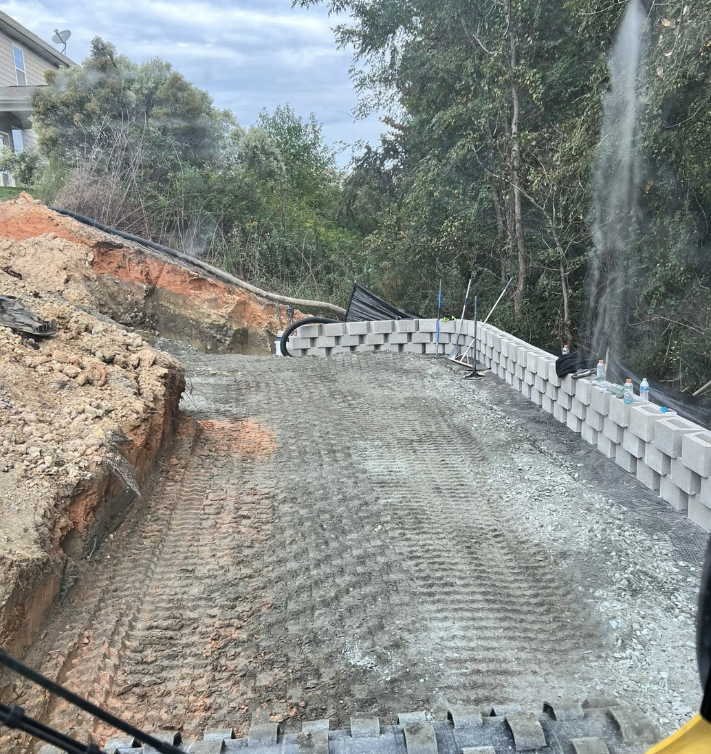 Retaining wall installation completed in Harrisburg, NC to maximize usable outdoor space.