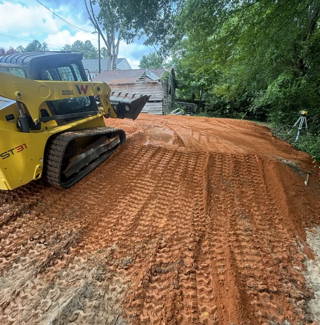 Complete excavation, land clearing, grading, gravel driveway installation, retaining wall construction, drainage solutions, erosion control, and site preparation completed by Palmetto South Construction, proudly serving York County, SC, Lancaster Cou