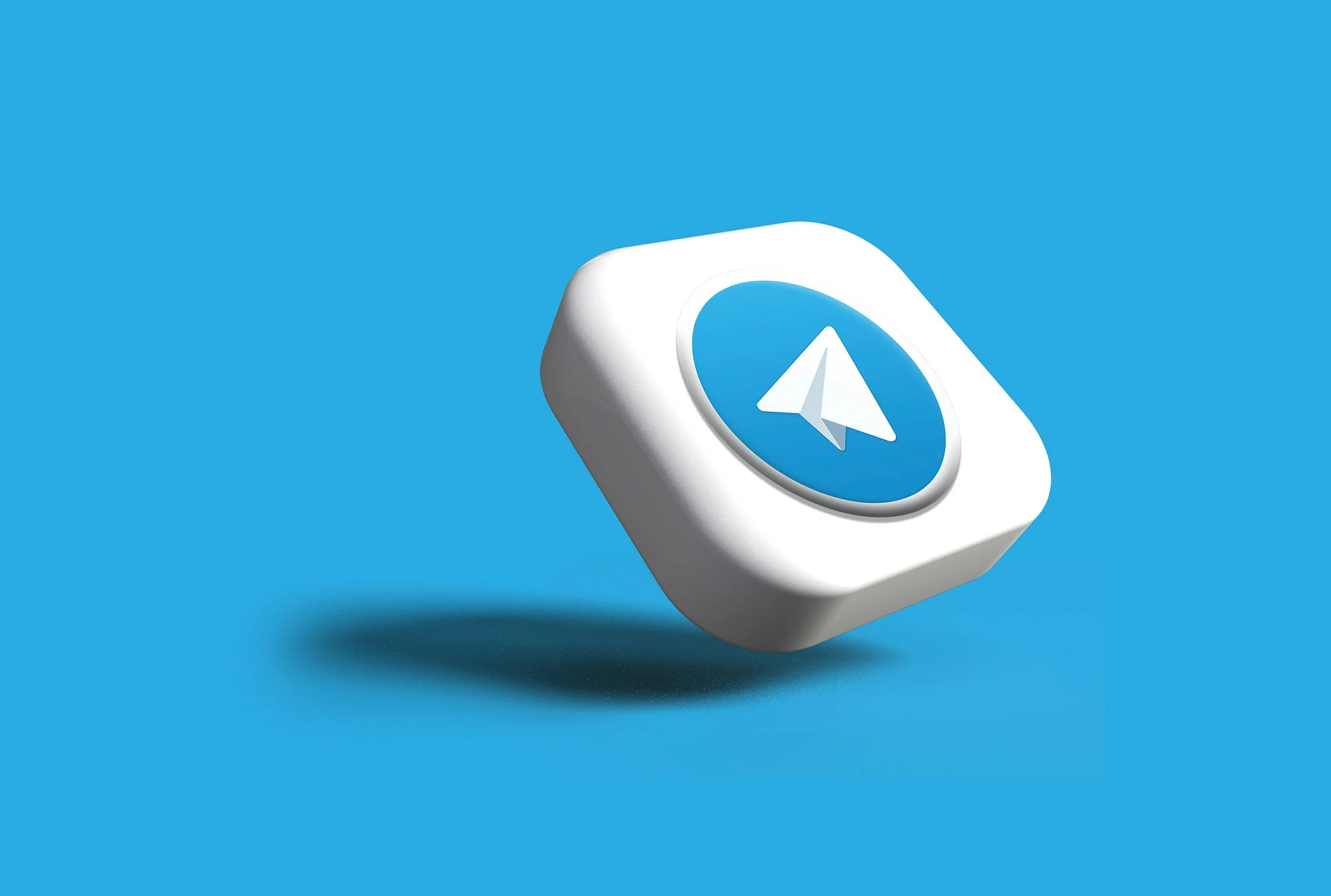A white cube with a blue circle and a white paper airplane icon on top of it, floating against a blue background.