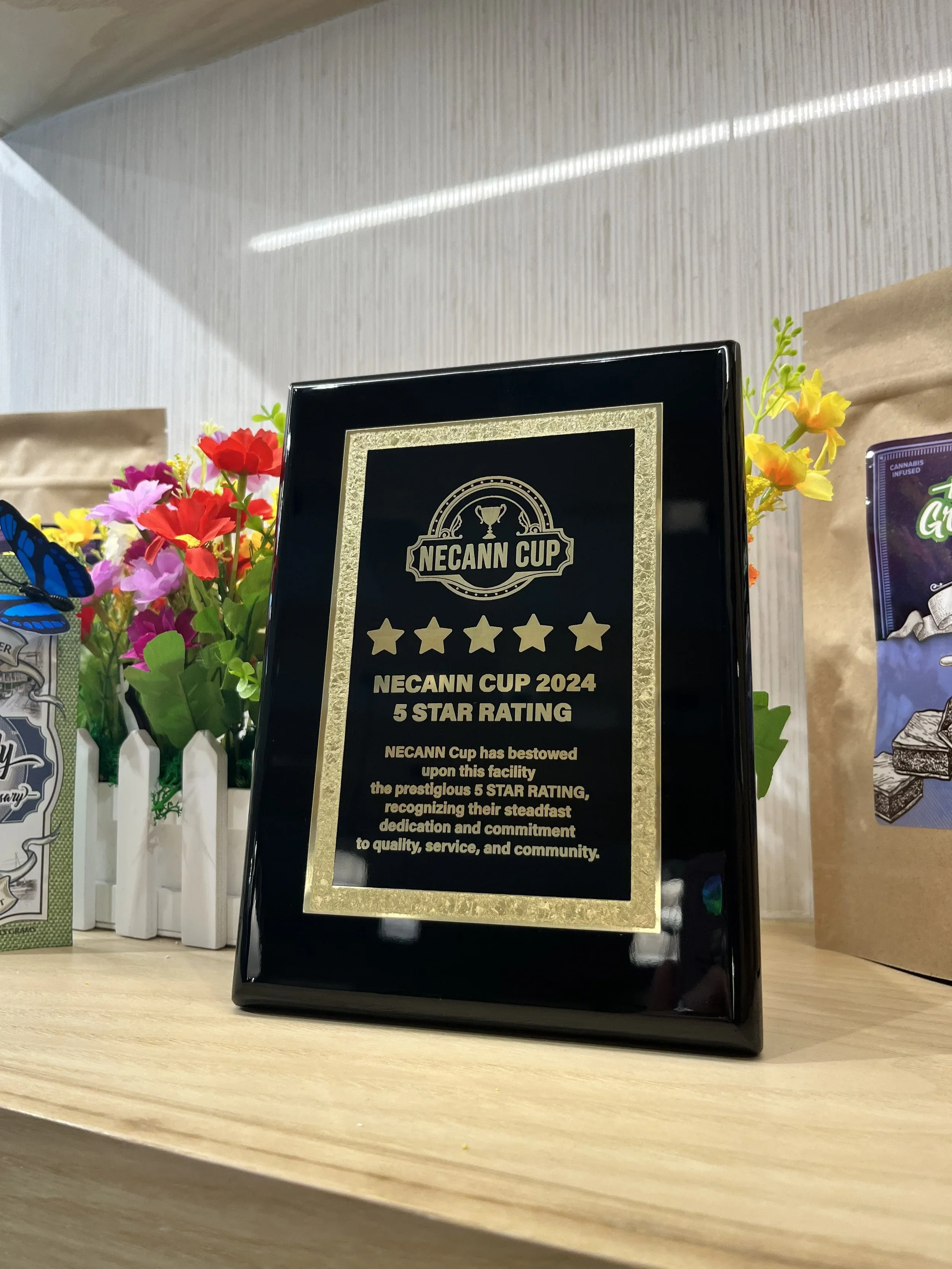 An award from the NECANN Cup 2024 5 star rating displayed on a shelf