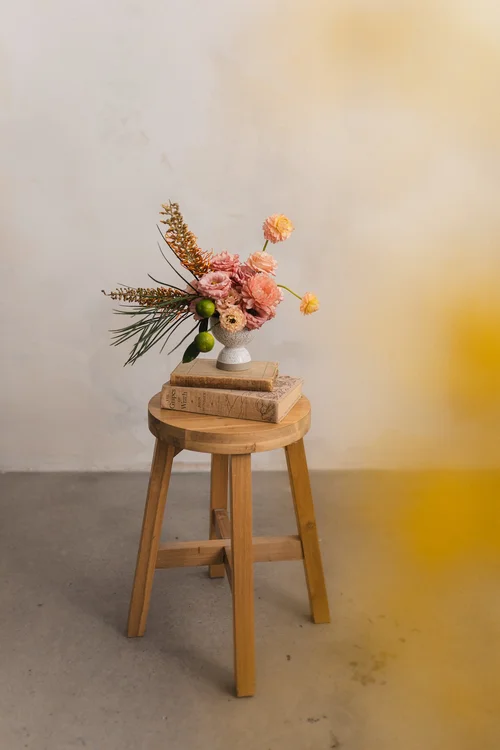 Floral arrangement on a stack of old books