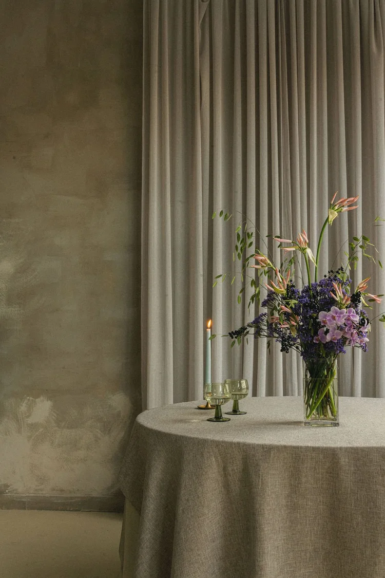 Flowers on a linen-covered table in a softly lit room
