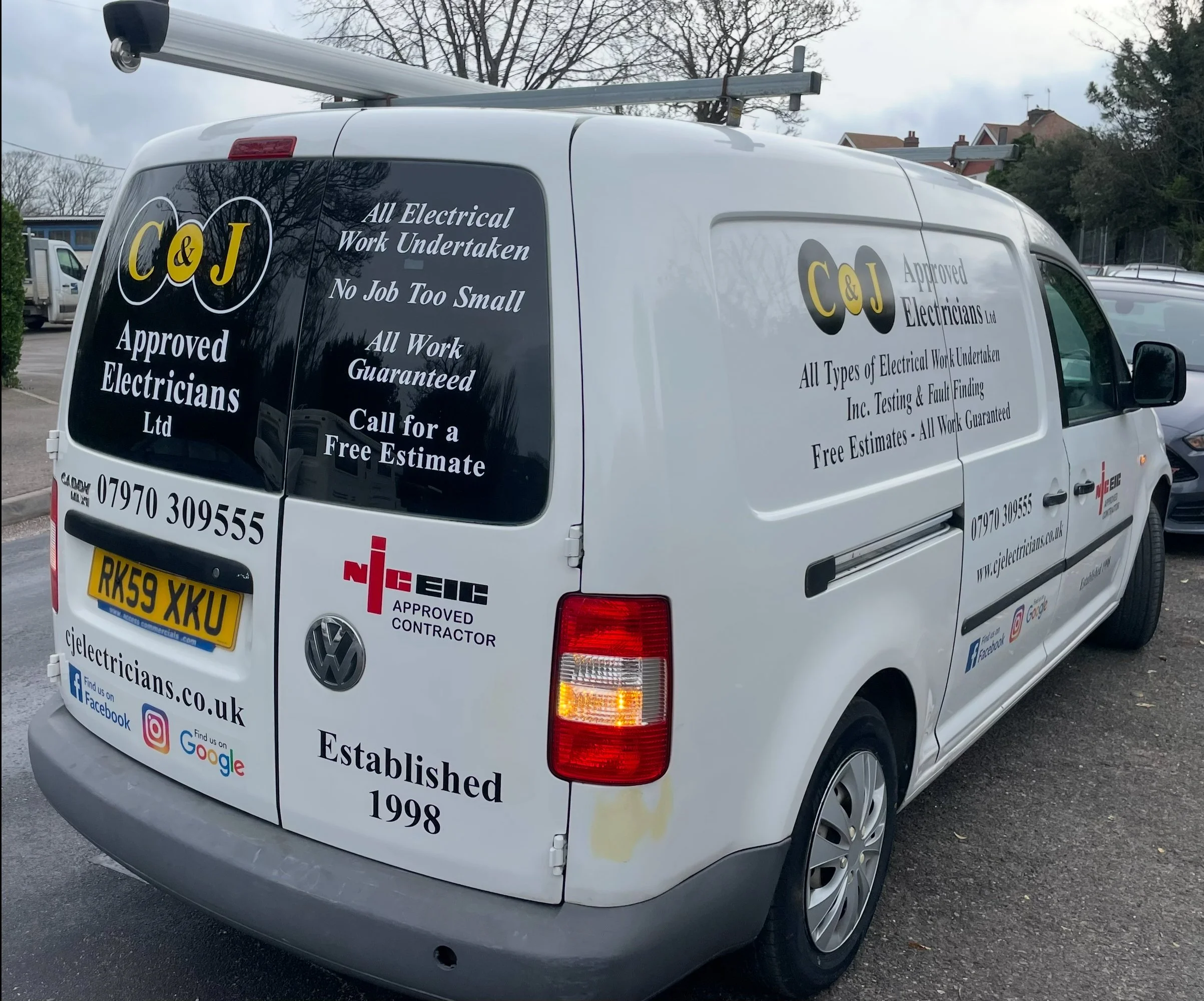 C&J Approved Electricians Ltd electrical contractor van displaying domestic and commercial services.