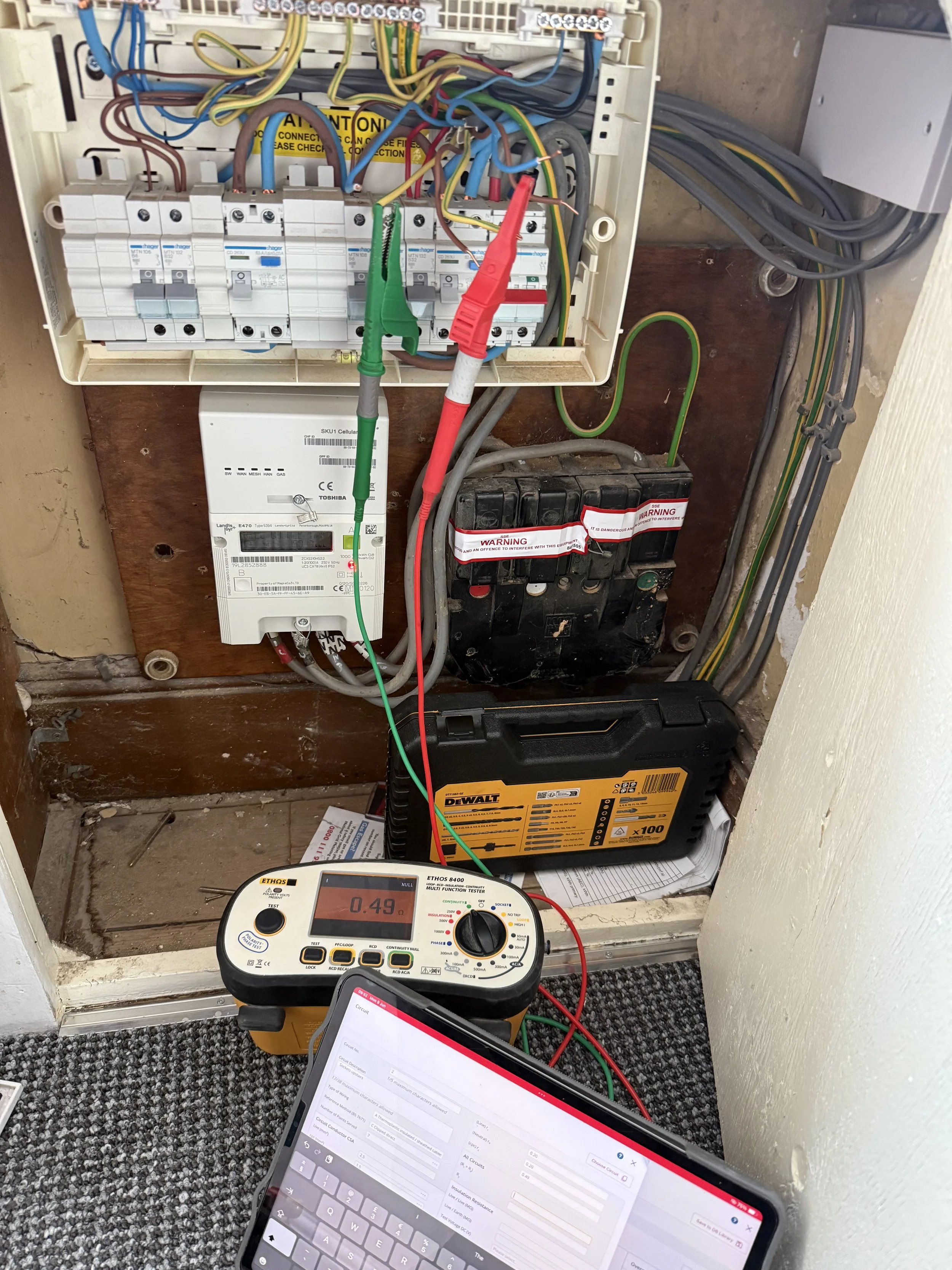 Electrical inspection and testing equipment connected to a consumer unit during fault-finding work.