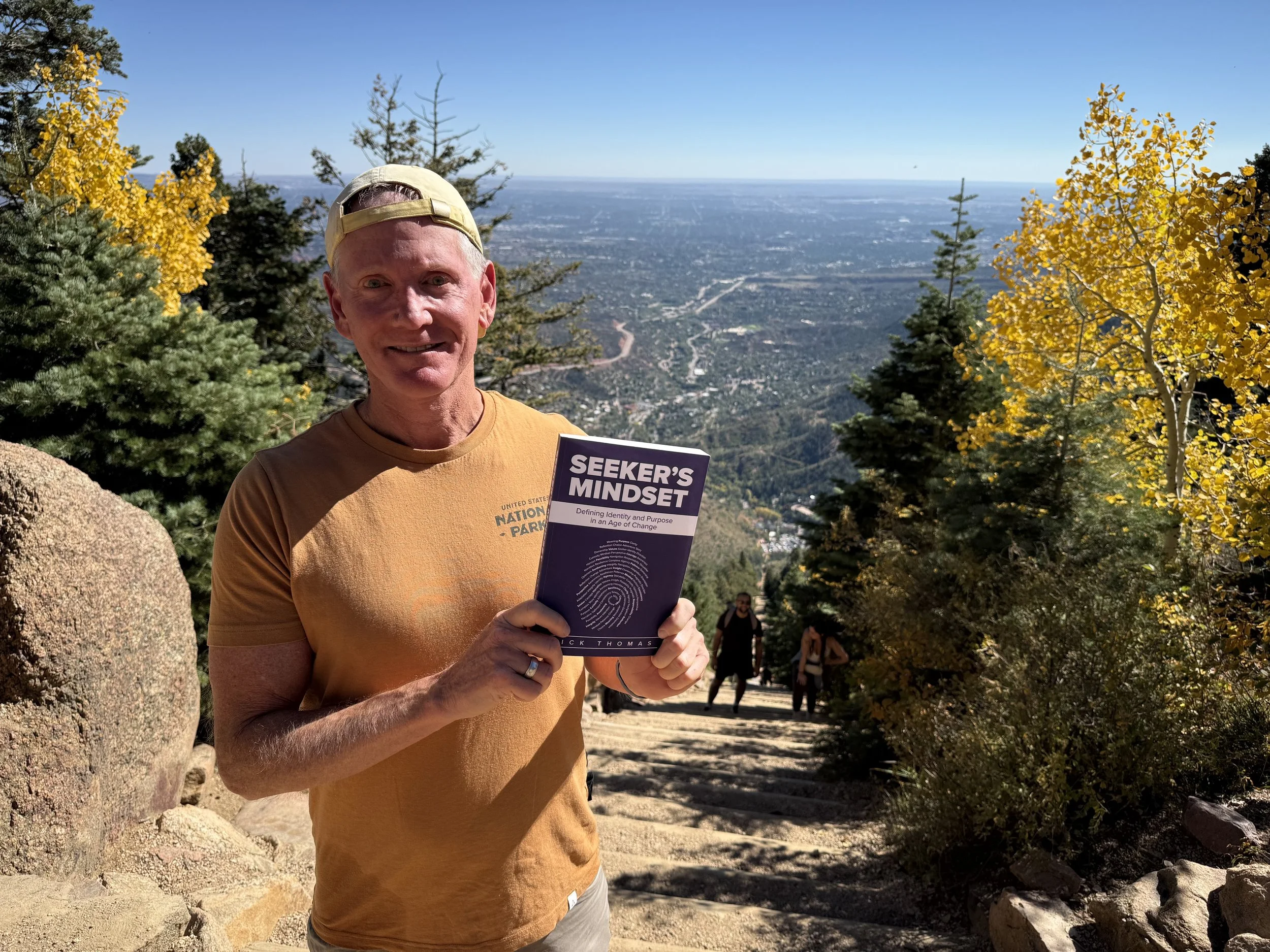 Rick Thomas holding Seeker's Mindset Book
