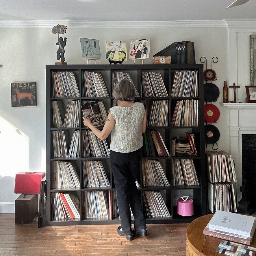 CJ Juska admiring her vast vinyl record collection.