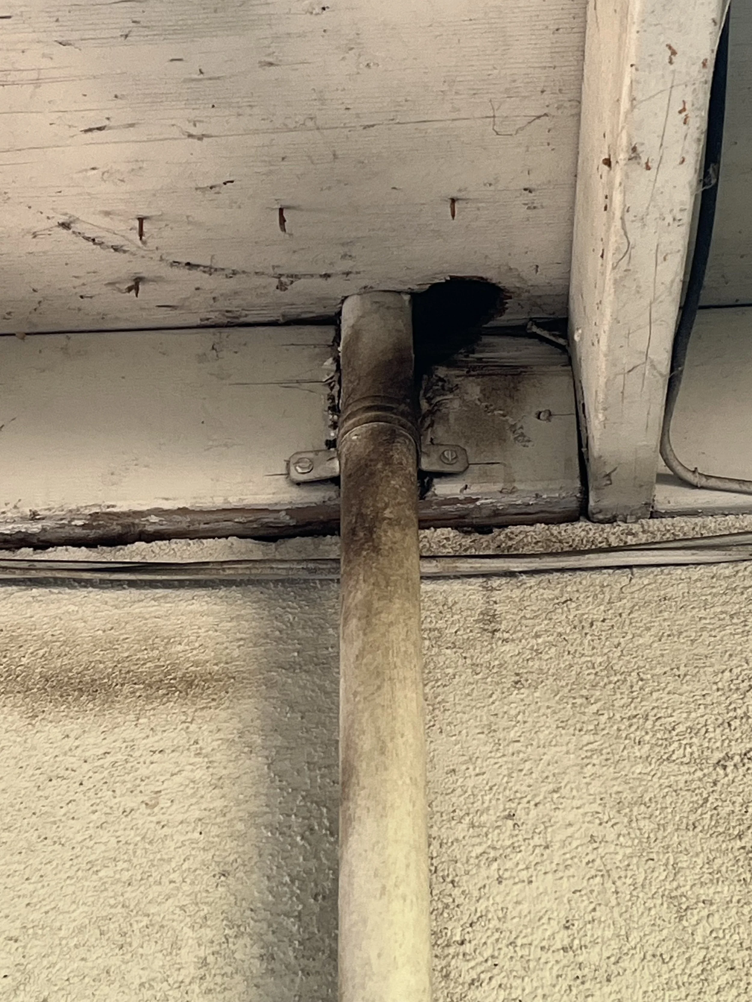 Close-up of rub marks left by Rats leading to a hole in an eave leading to the attic.