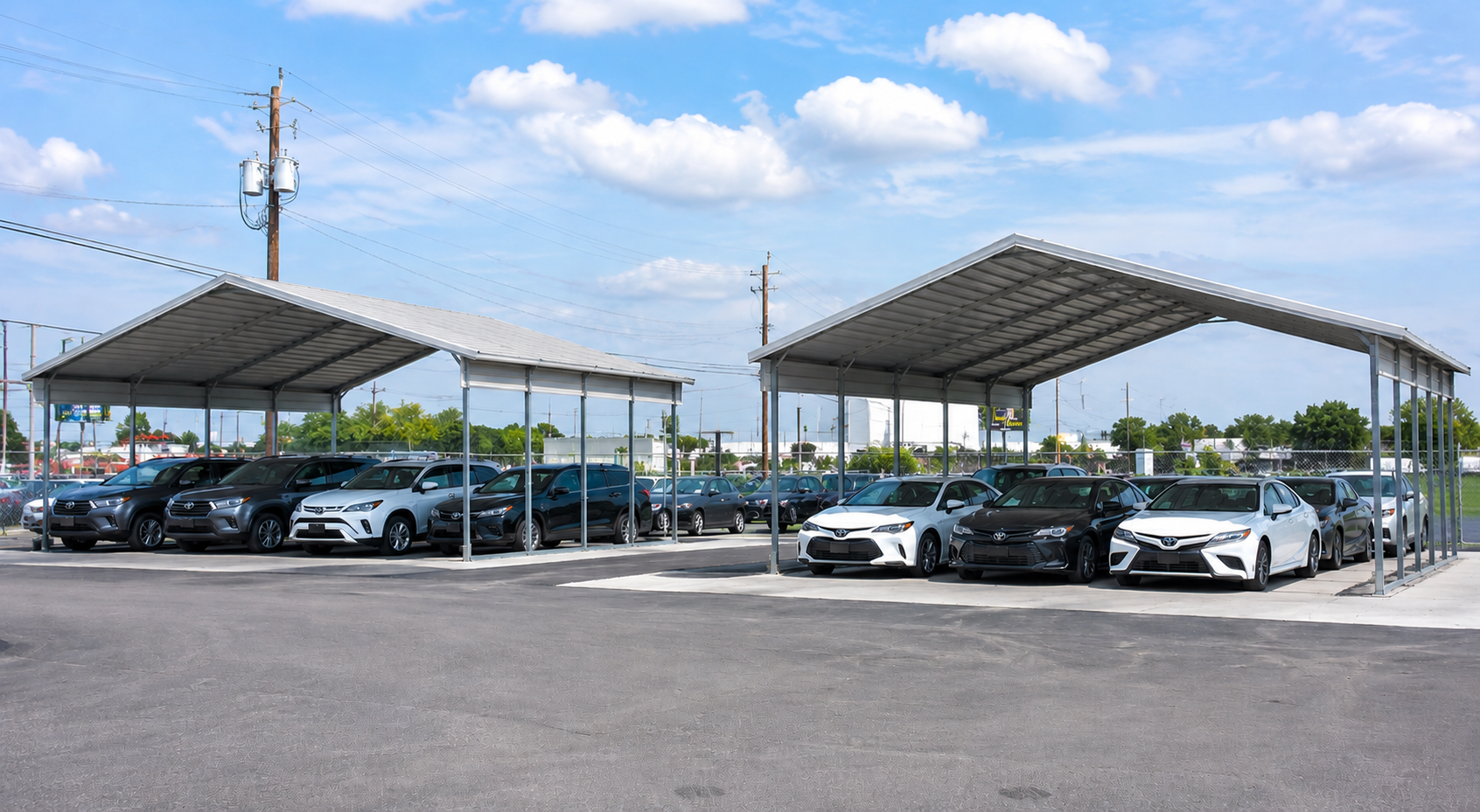 Commercial metal carports protecting vehicles at a dealership