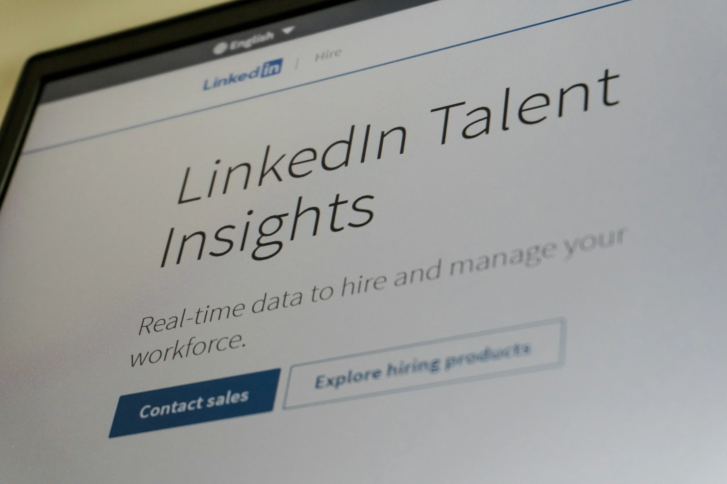 Computer screen displaying a webpage titled 'LinkedIn Talent Insights' with options to explore hiring products and contact sales.