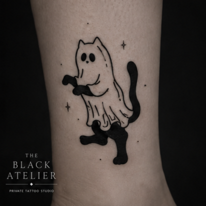 Tattoo of a cartoon cat dressed as a ghost, with black gloves and shoes, on a person's skin.