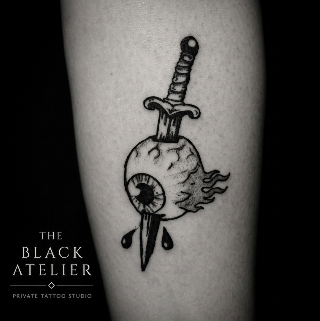 A tattoo of a melting eyeball with a dagger through it on a person's skin.