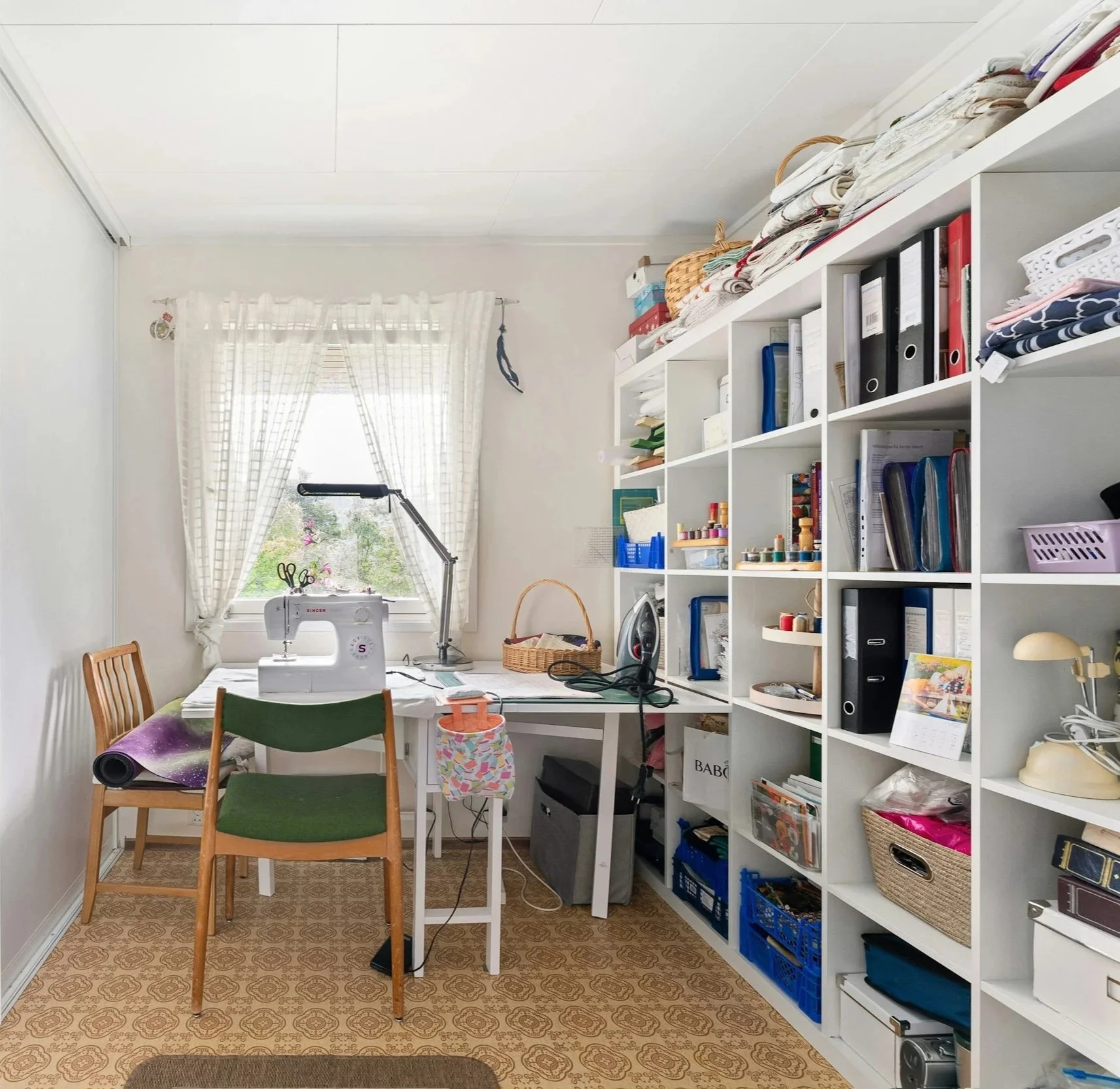 A craft room with display shelving and organized storage — before and after home organizing in mid-coast Maine