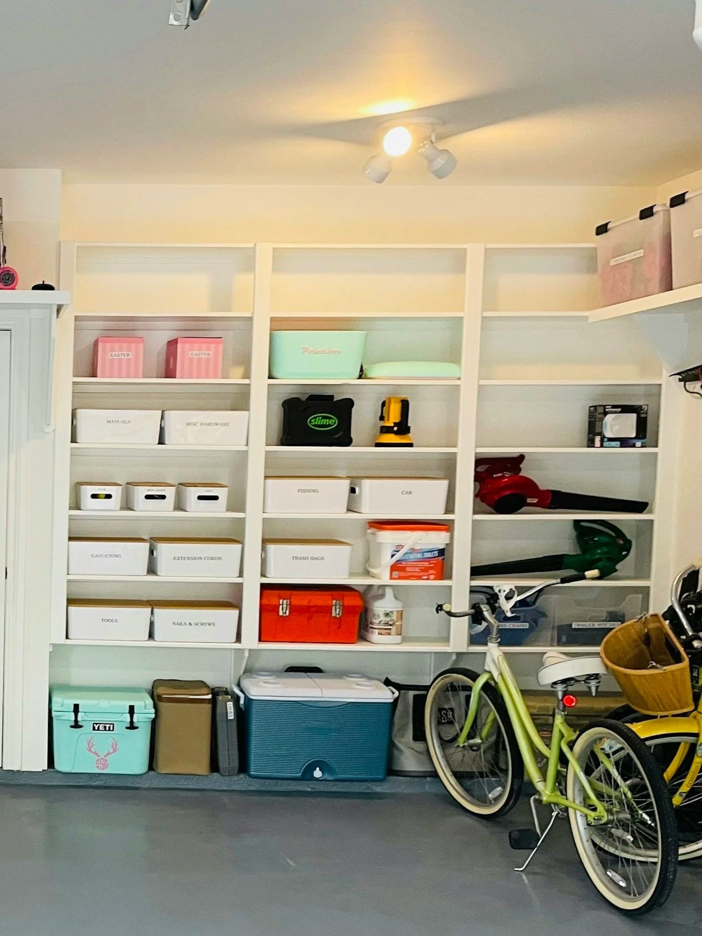 A beautifully organized garage with labeled storage bins and shelving — professional home organizing services for every space in mid-coast Maine