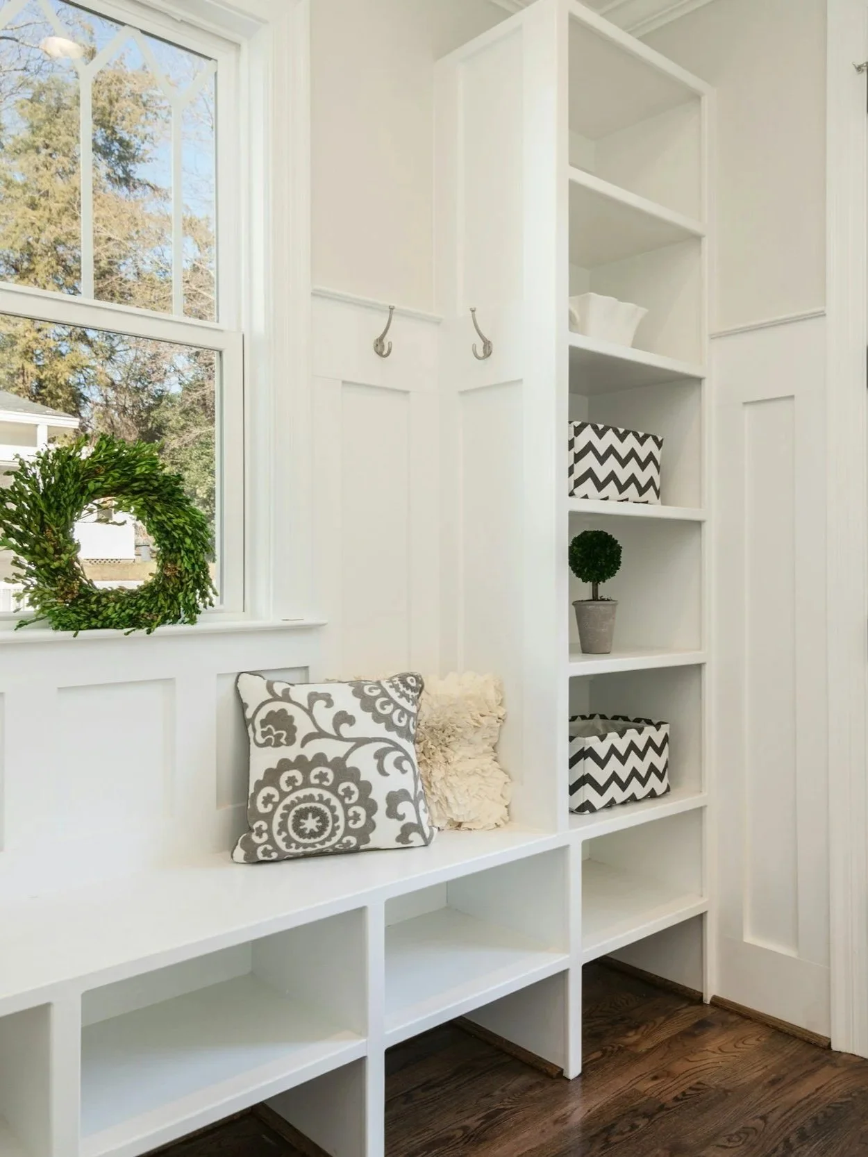 A beautifully organized mudroom with built-in shelving and storage baskets — home organizing inspiration from Room by Room