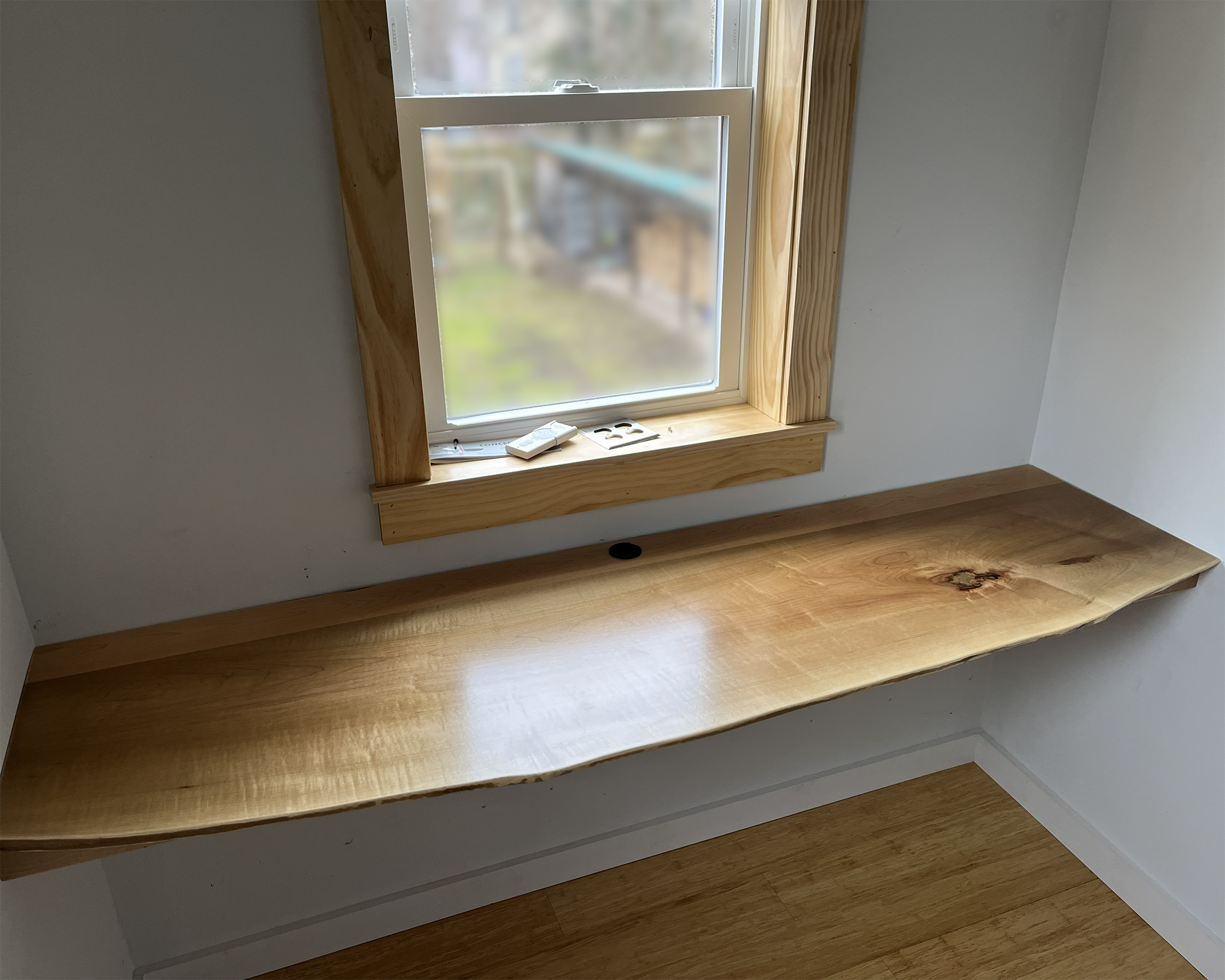 Raw edge desk at a window