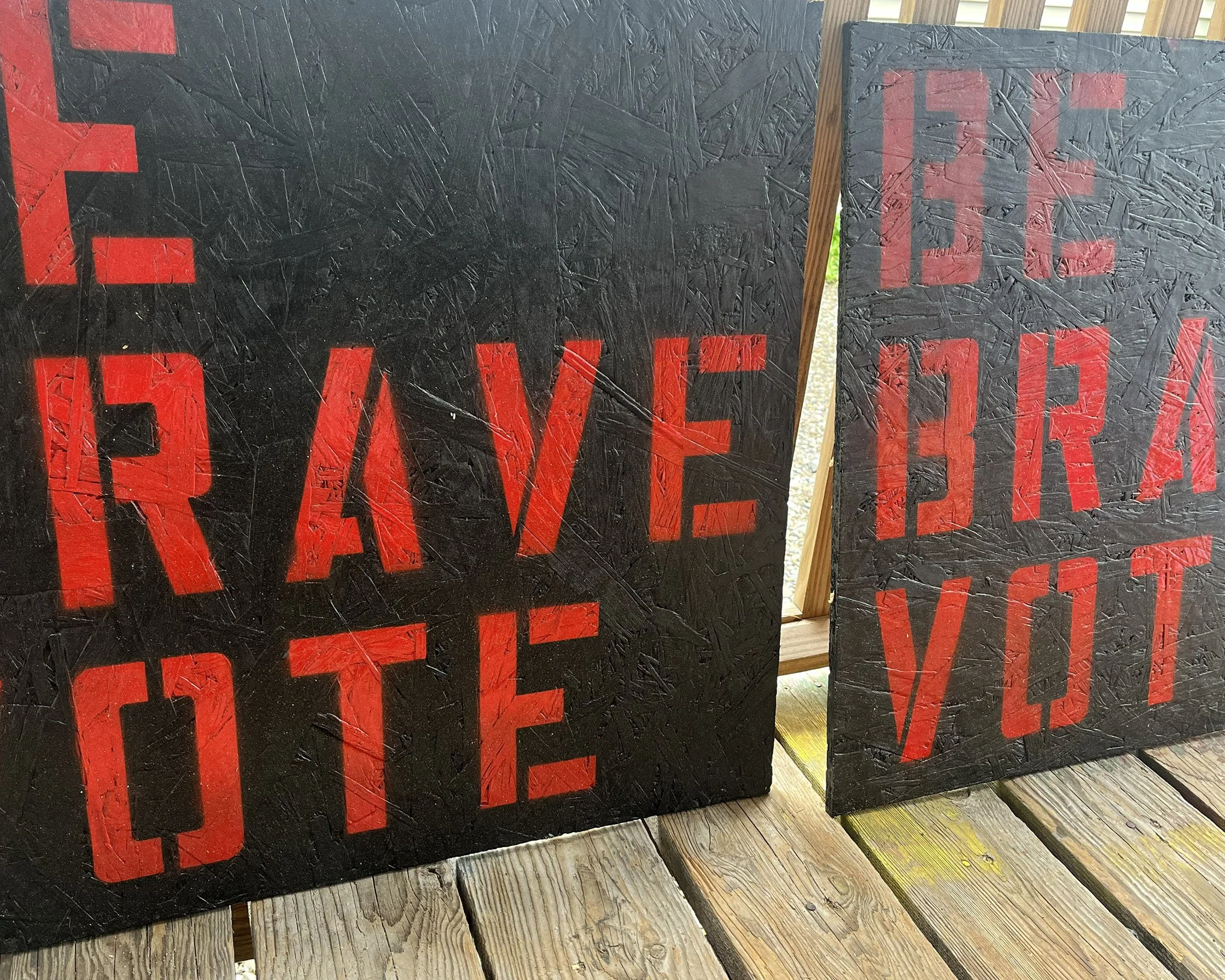 stenciled artwork that reads 'be brave vote' in red on black