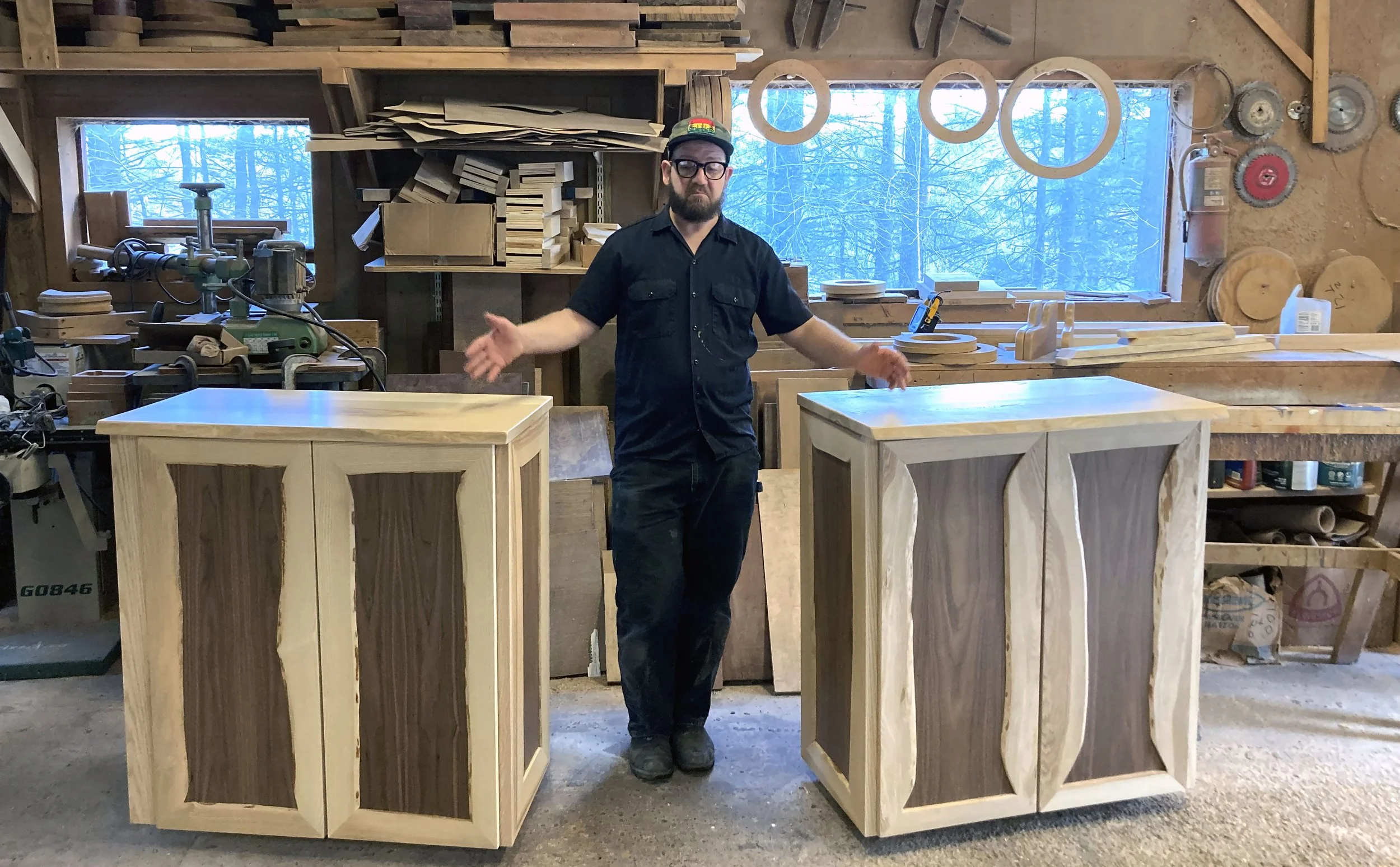 Speiser standing between two custom cabinets with raw edge trim and contrasting wood species