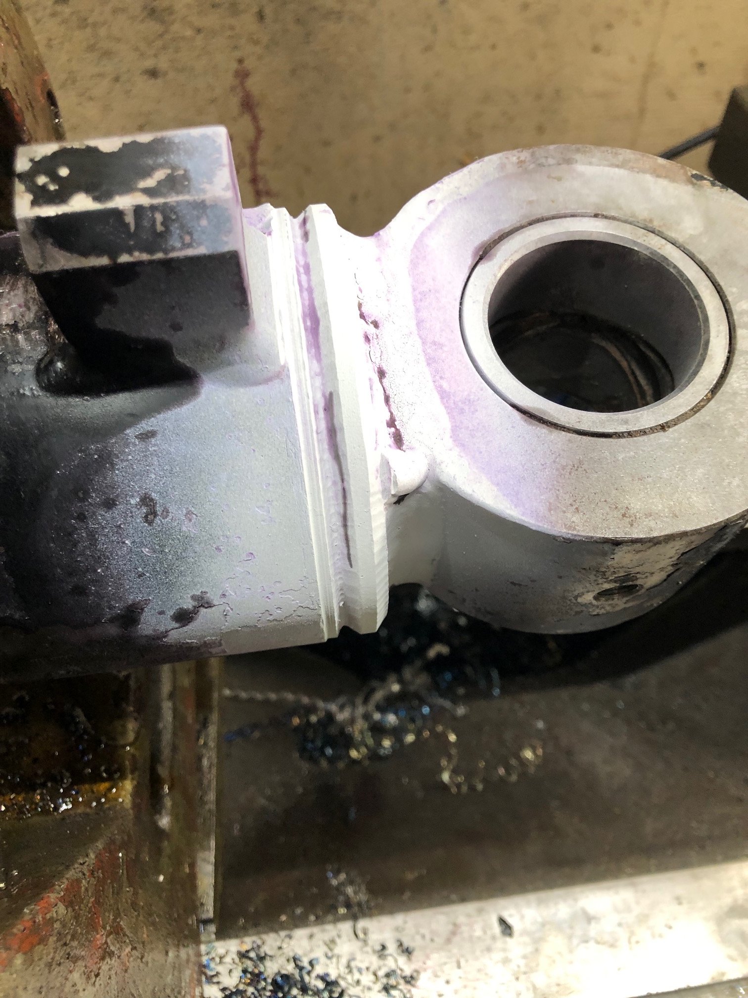 Heavy equipment repair, hydraulic cylinder crack weld repair in progress.