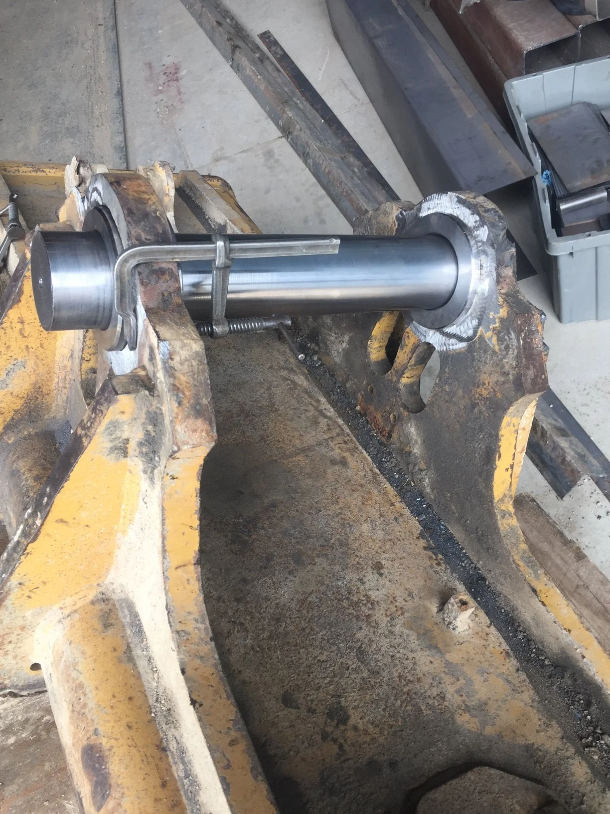 Heavy equipment repair, tilt bucket attachment replacement bushings and pins in progress.
