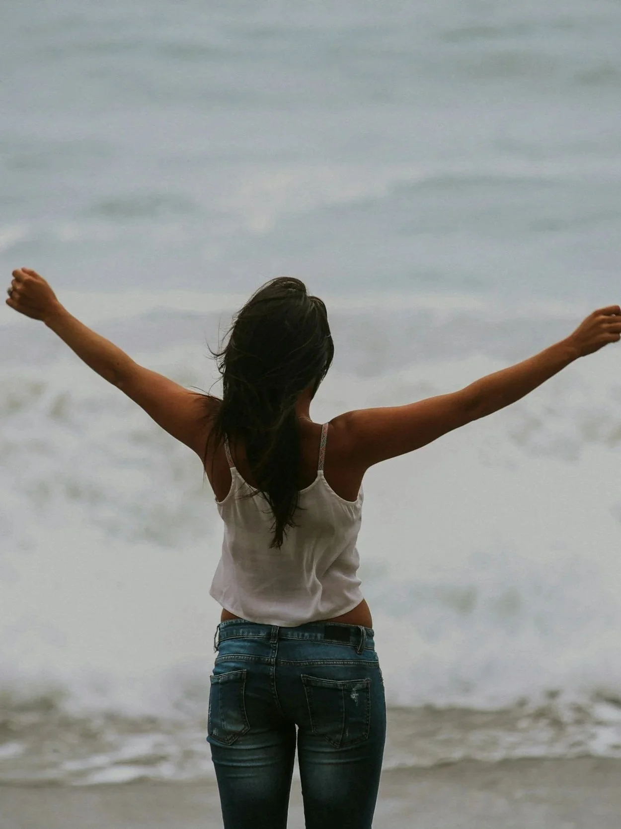 Woman on beach feeling empowered