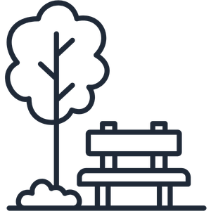 Silhouette of a tree and a park bench in a park scene.