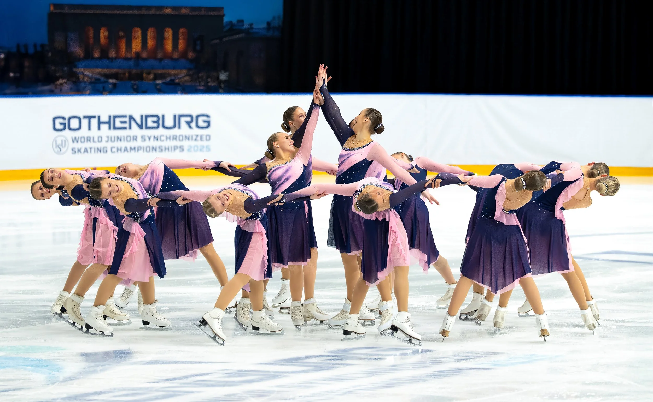 A synchronized figure skating team performing on ice at the Gothenburg 2025 World Junior Synchronised Skating Championships.
