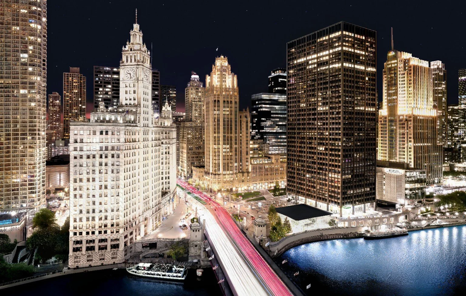 Night view of a city skyline with illuminated skyscrapers along a river, a bridge with light trails from moving vehicles, and a starry sky above.
