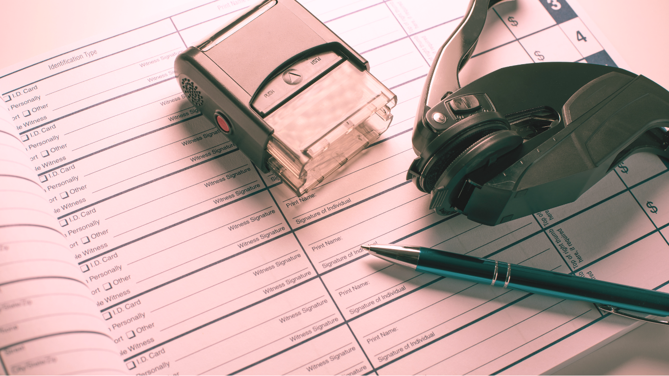 A pen, a stapler, a pair of black headphones, and a blue pen placed on a document or form with printed text and checkboxes.