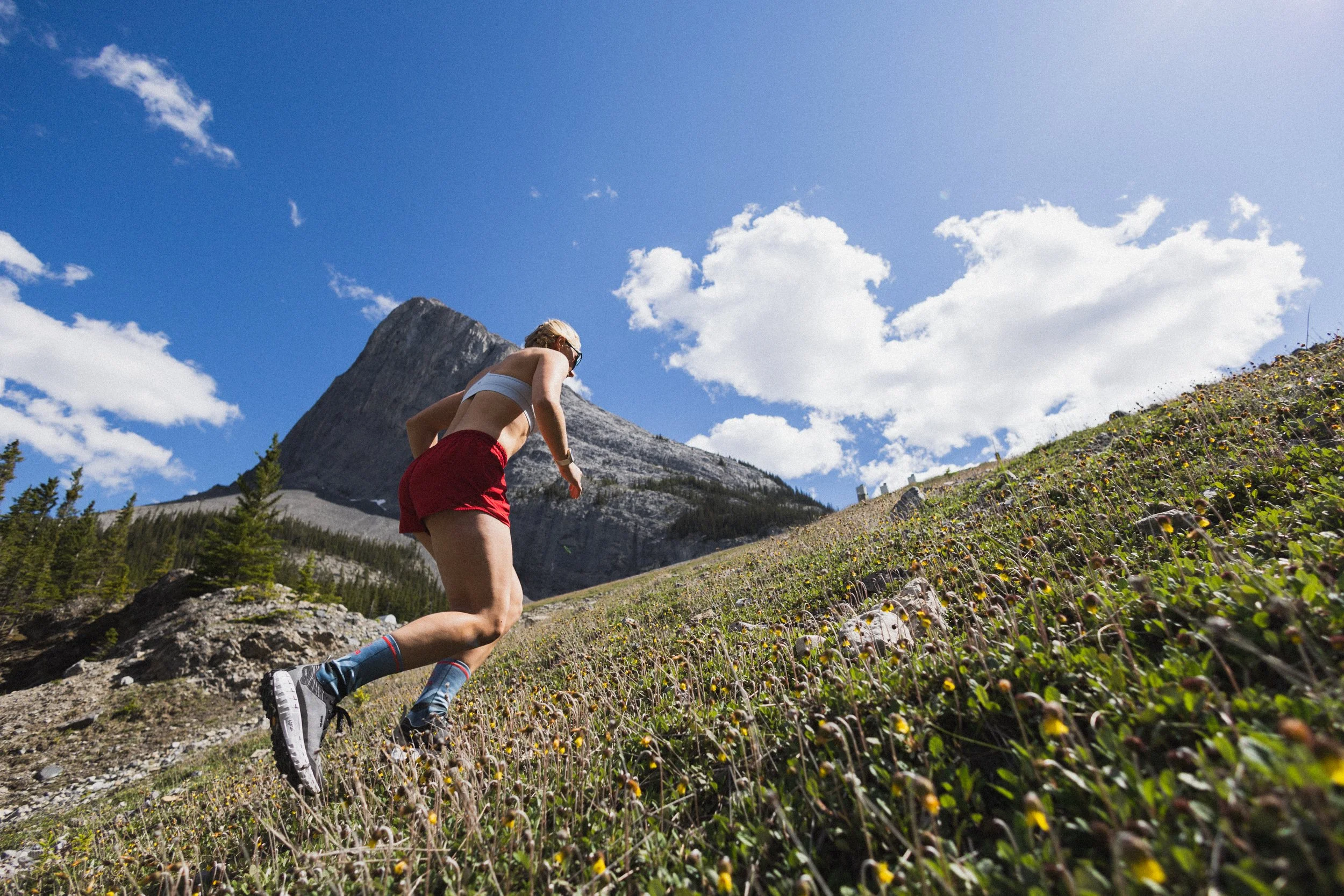 Sonjaa Schmidt runs up a mountain in Norda shoes