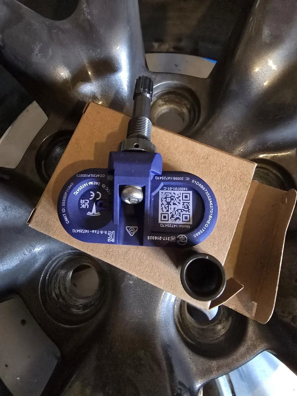 Tesla TPMS snsor ready to be installed on a rim.