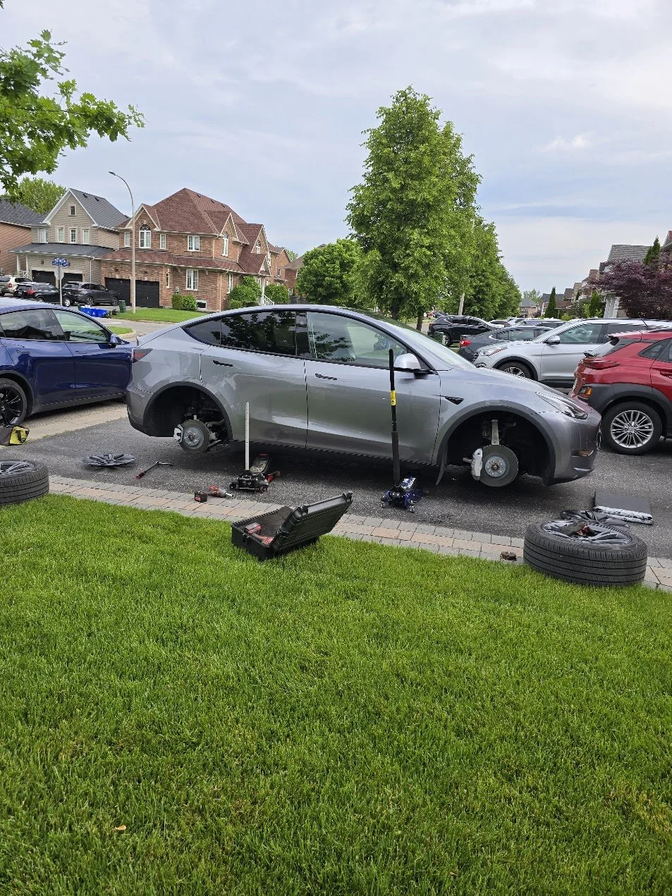Tesla mobile tire rotation in customer's driveway in Whitby, Ontario.