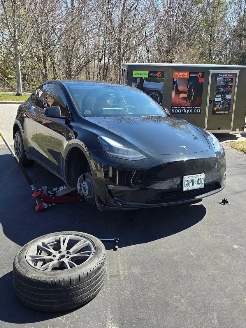 EV Mobile Tire Repair Service - repairing a punctured tire on a Tesla Model Y.
