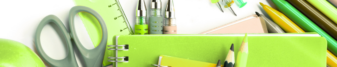 School supplies including scissors, highlighters, pens, pencils, a ruler, and a green notebook with a yellow sticky note, arranged on a white surface.