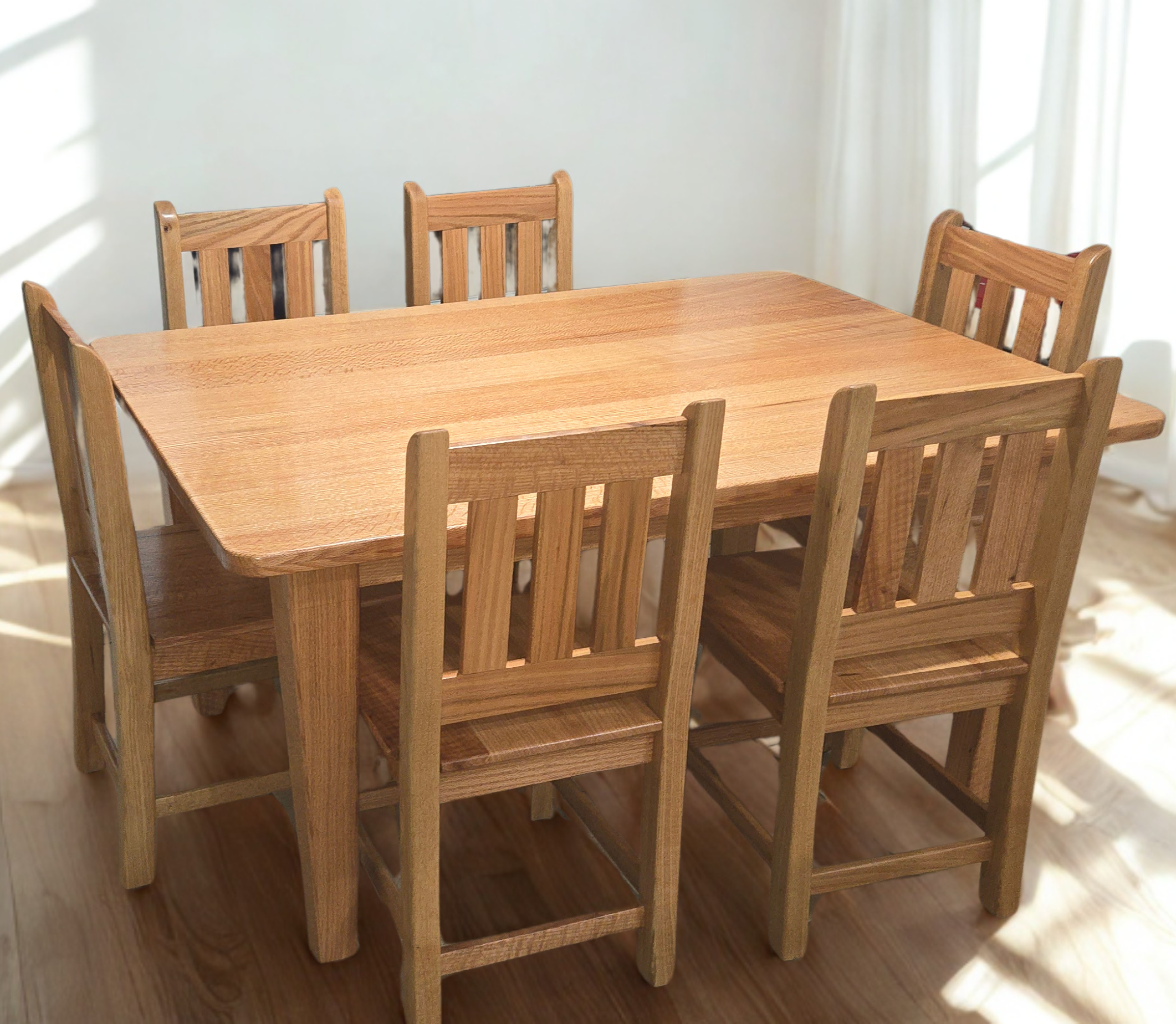 A wooden dining table with six matching chairs in a sunlit room, with sunlight creating shadows on the wall to the left.