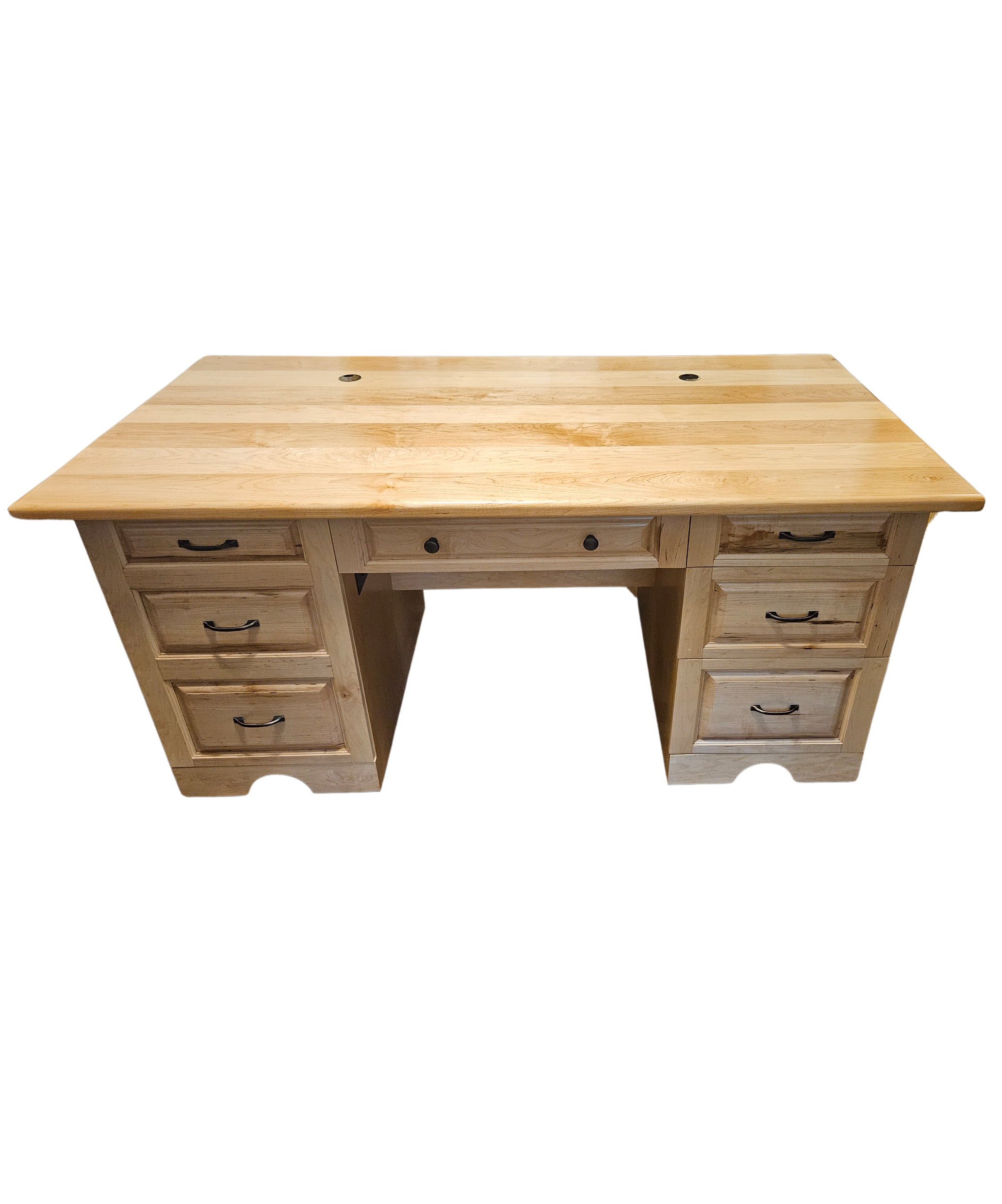 A wooden desk with multiple drawers and black handles, topped with a light-colored wooden surface. Part of the desk is visible from an overhead perspective.