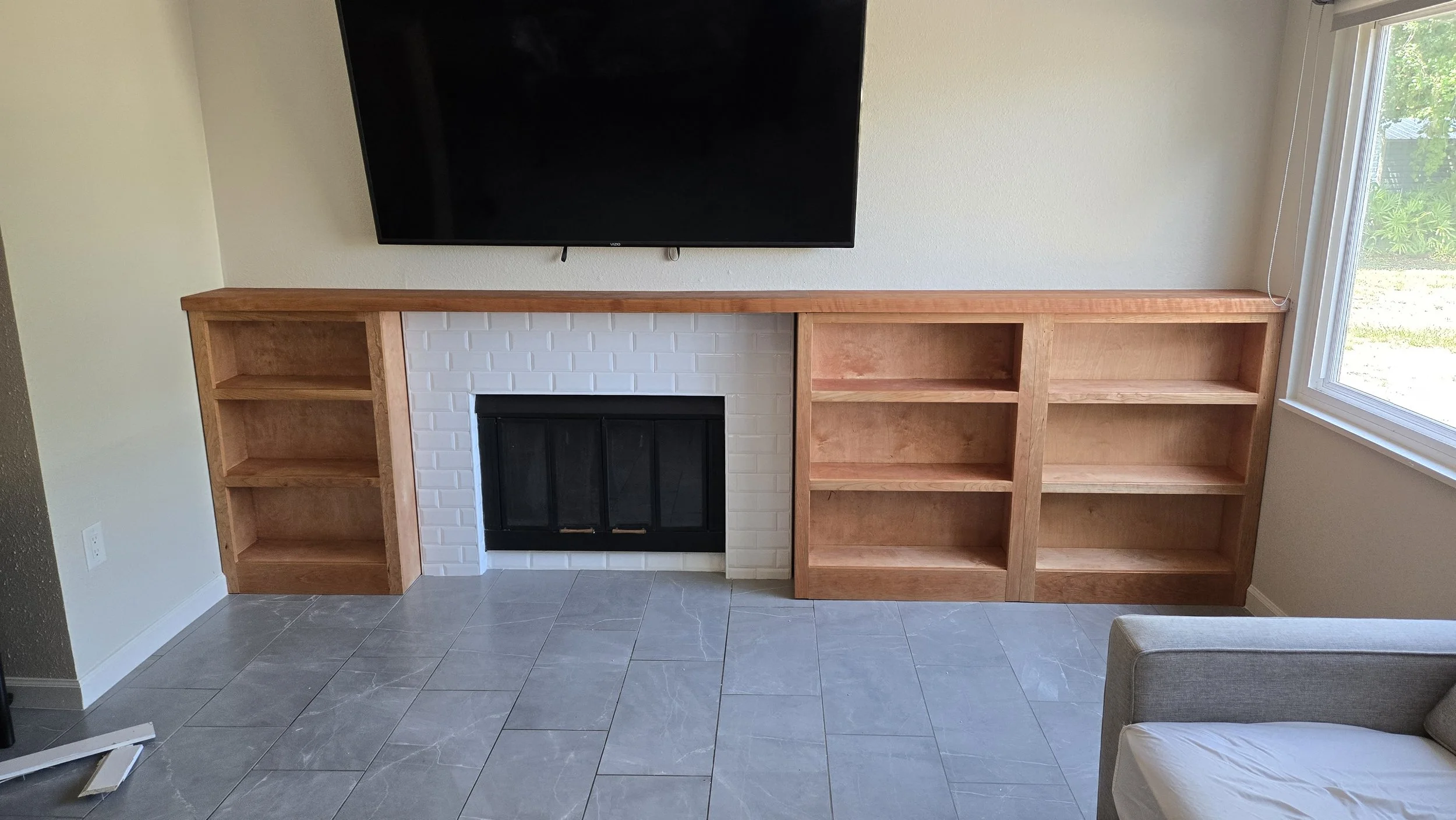 Custom Cherry Built-In Bookshelves with Fireplace Mantel
Matching built-in bookcases flanking an existing fireplace, tied together with a solid cherry mantel spanning the full wall. Finished in Rubio Monocoat to let the cherry's natural warmth come t