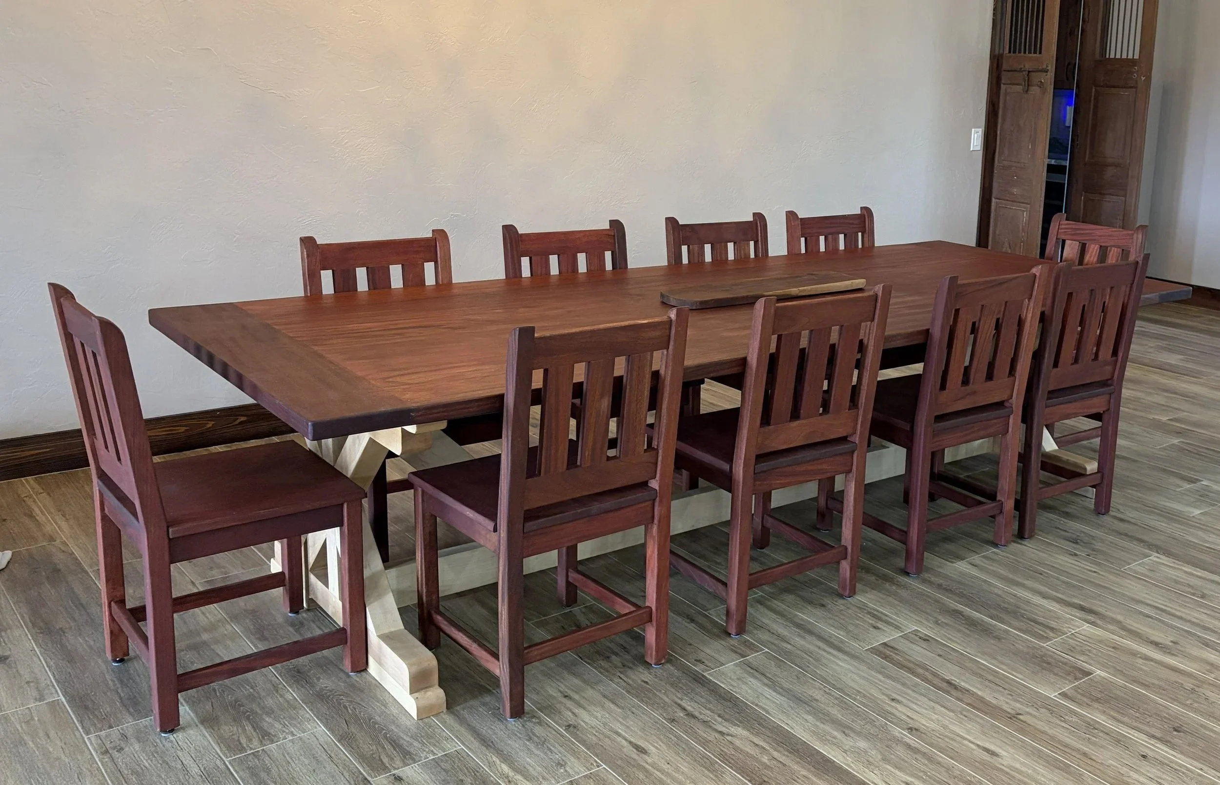 Custom mahogany dining table with maple trestle base, built by Poppy's Woodworking and Furniture in Summerfield, FL