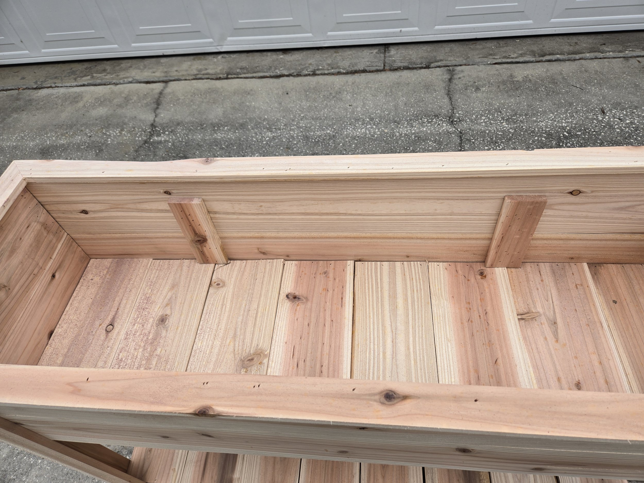Close-up of interior support divider inside cedar raised garden planter