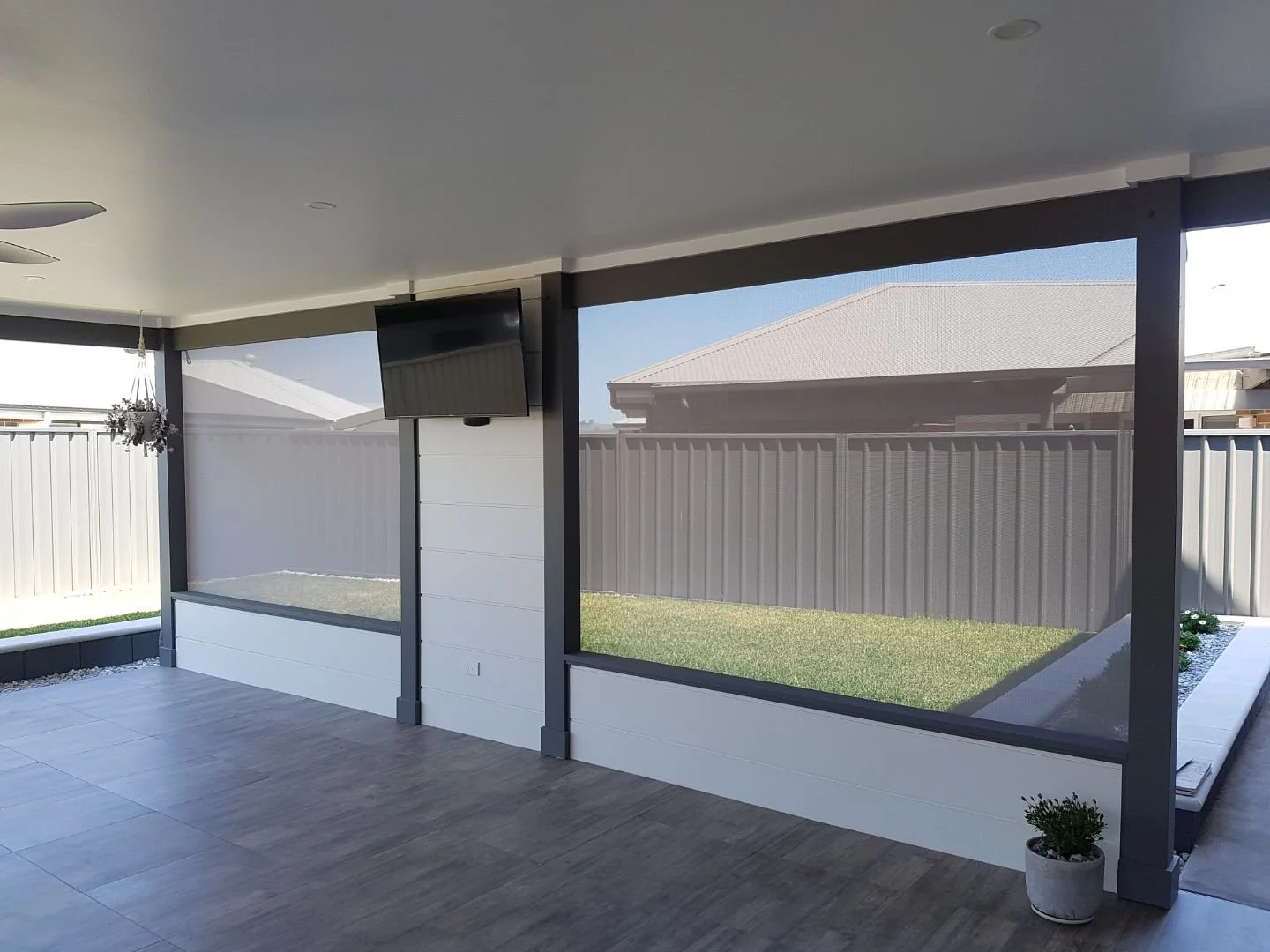 Straight drop blind softly filtering light in entertainment area