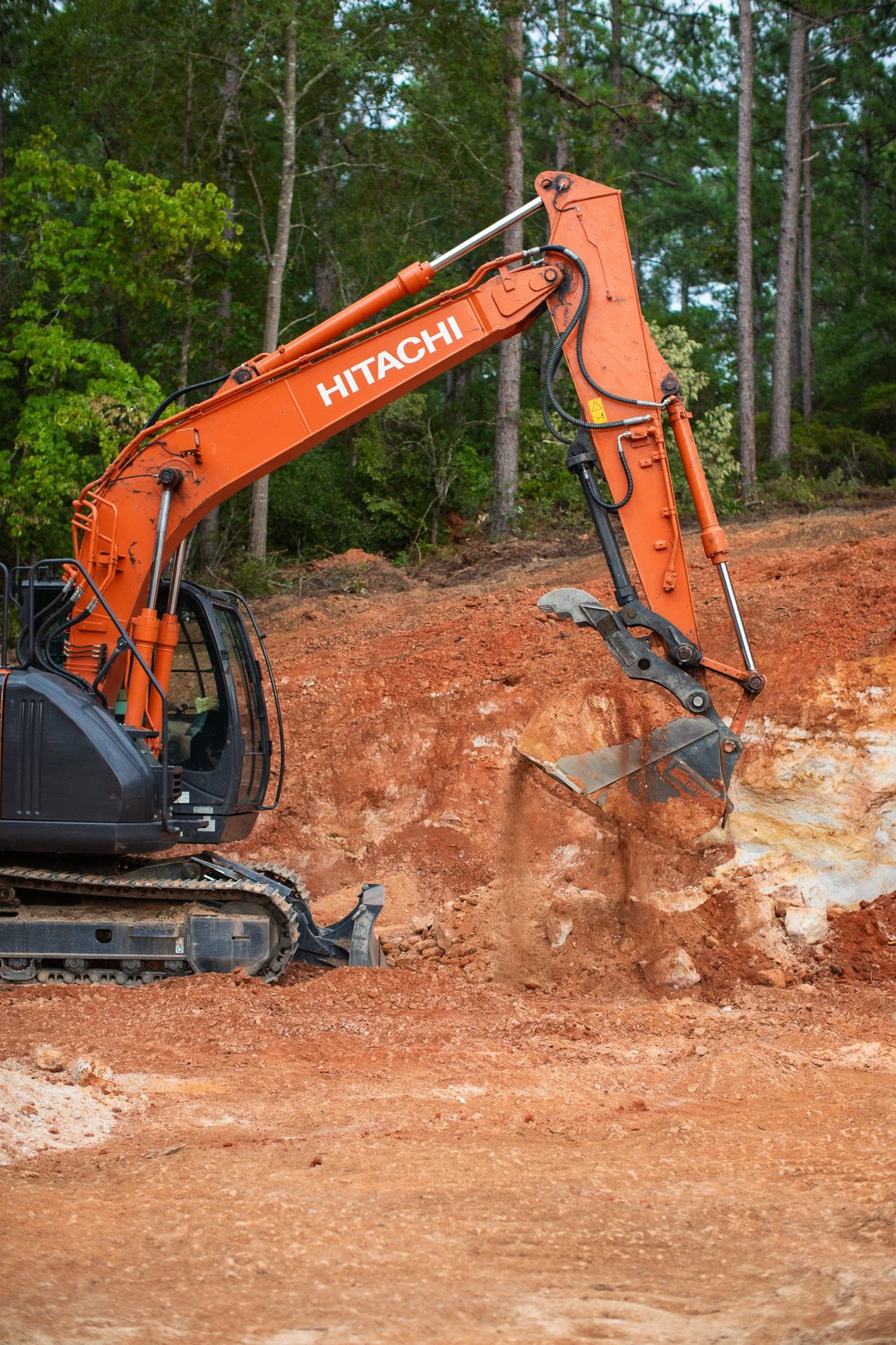 Excavation equipment hauling dirt and materials for a property improvement project near Aiken, SC.