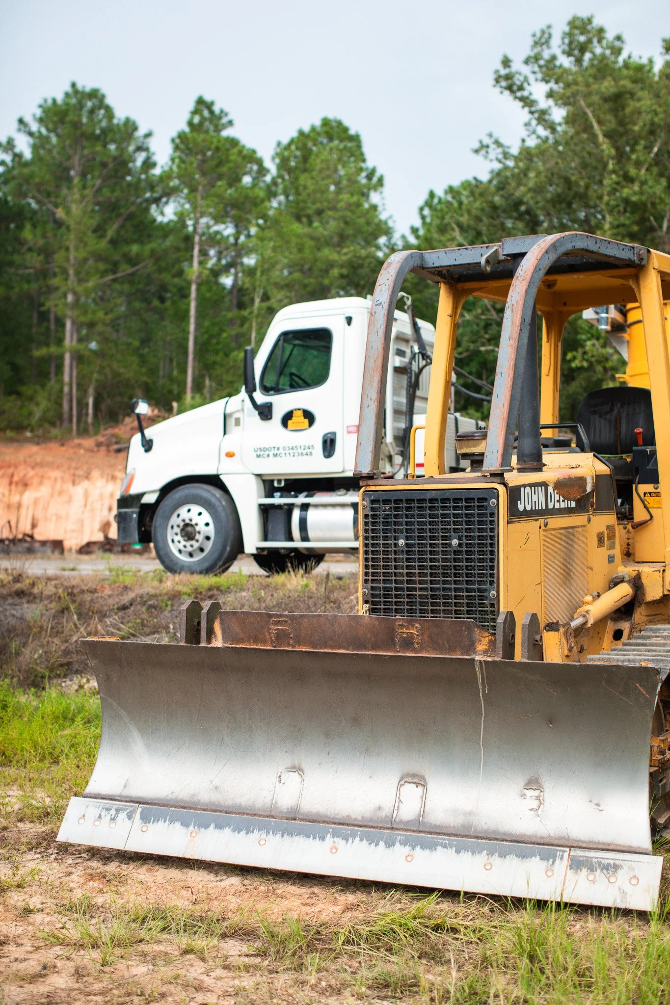 Construction equipment for new rock driveway installation on a rural property near Aiken County, SC