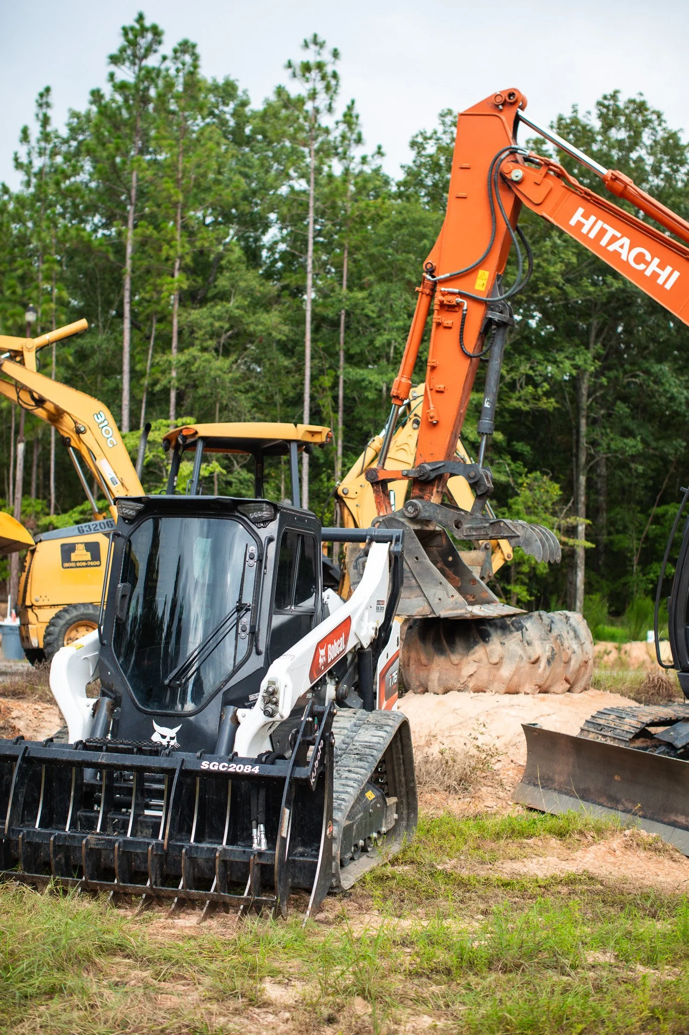 Construction excavator equipment leveling ground during residential site preparation near Aiken, SC.