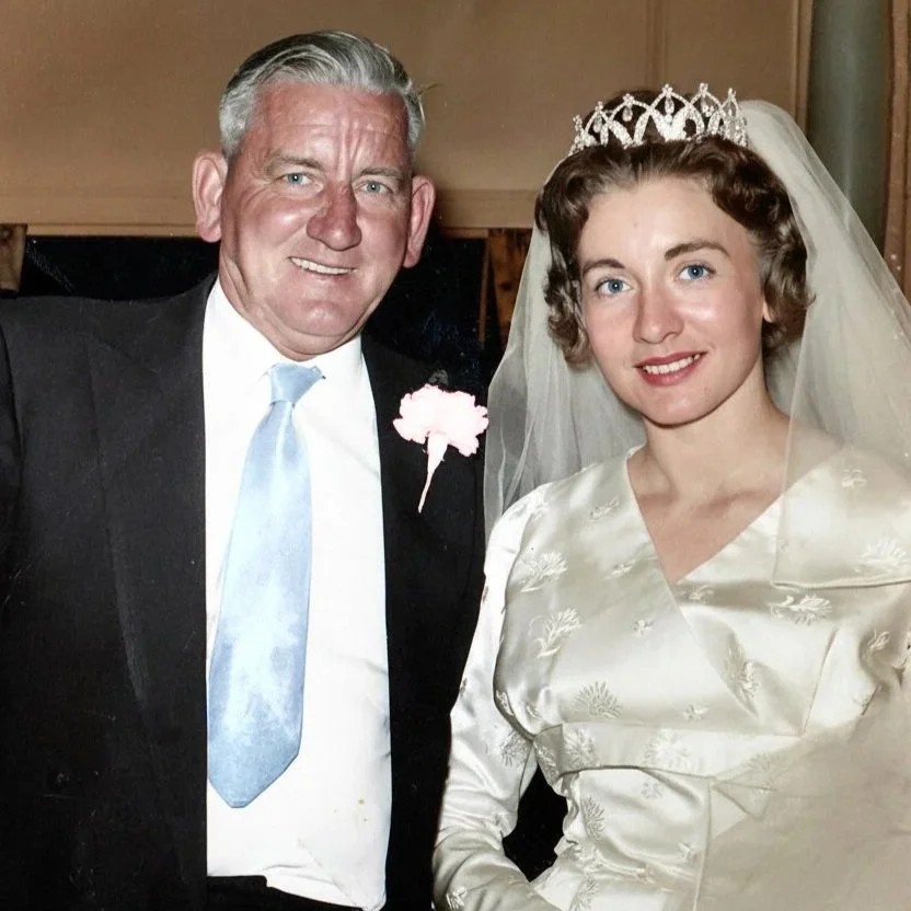 A colourised photo  of man in a black suit and light blue tie standing next to a woman in a wedding dress with a tiara and veil.