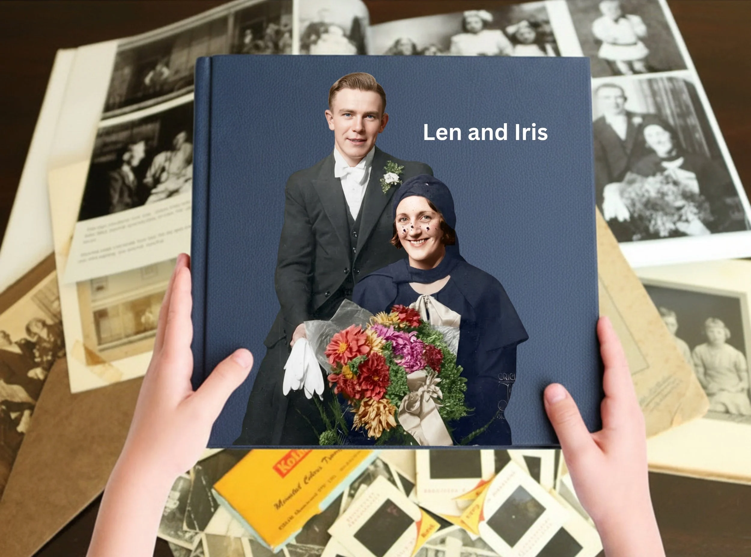 A person holding a MiVuw Photobook with a photo of a man and woman on the cover. The album is over scattered black and white photographs.