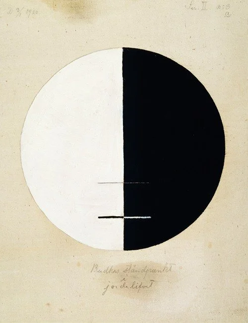 A drawing of a circle divided into half black and half white with two horizontal lines extending from the divide, and handwritten text below and above the circle.