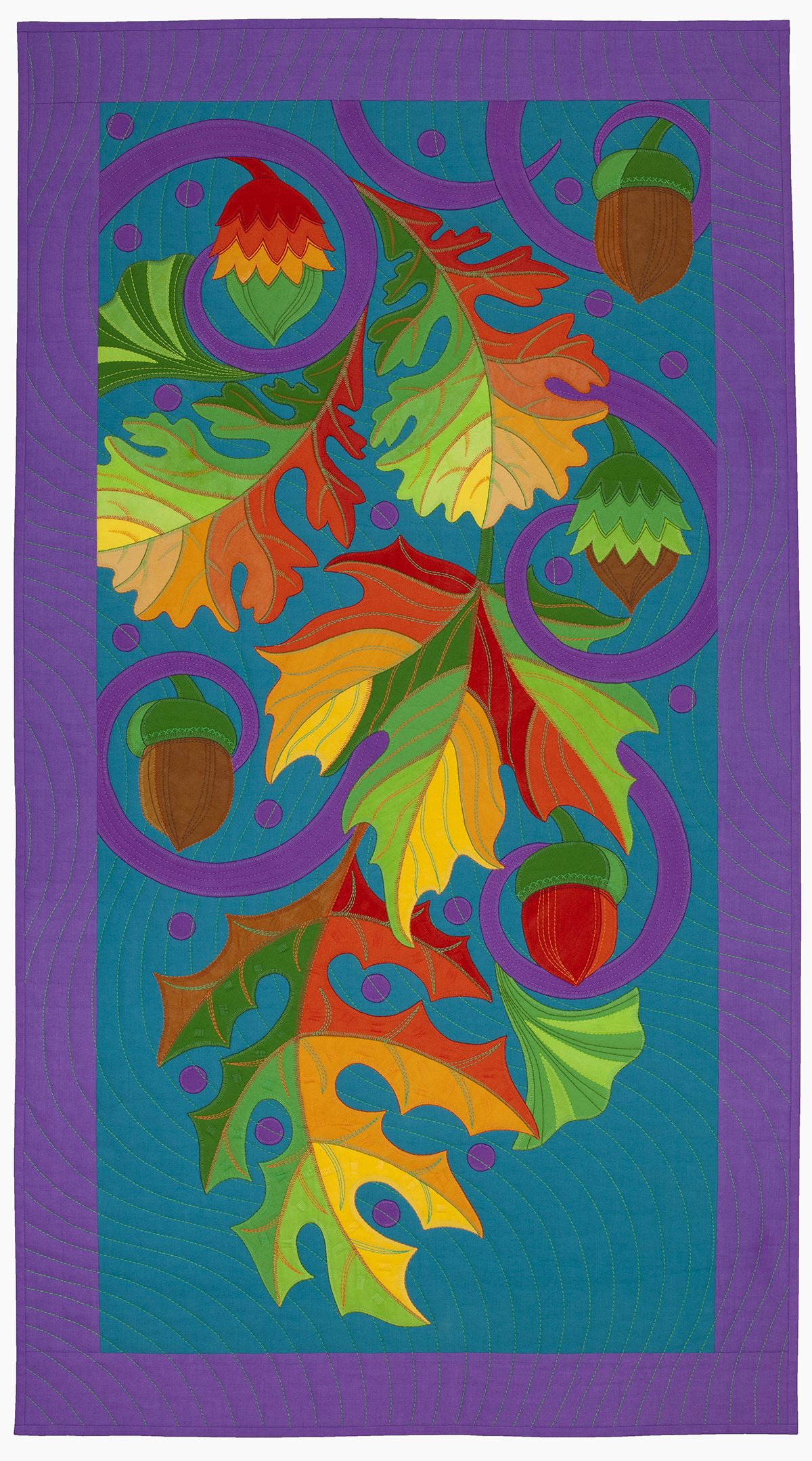 A colorful quilt featuring autumn leaves, acorns, and swirling patterns with a purple border and a blue background.