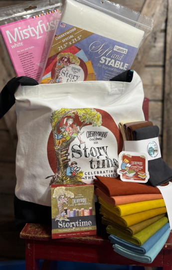 A tote bag and various Miscellaneous quilting or sewing supplies, including fabric, a Cherrywood Hand & Table pad, and quilting thread.