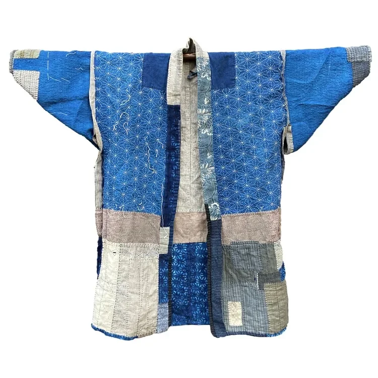 A traditional Japanese kimono made from patchwork fabric in various shades of blue and beige.